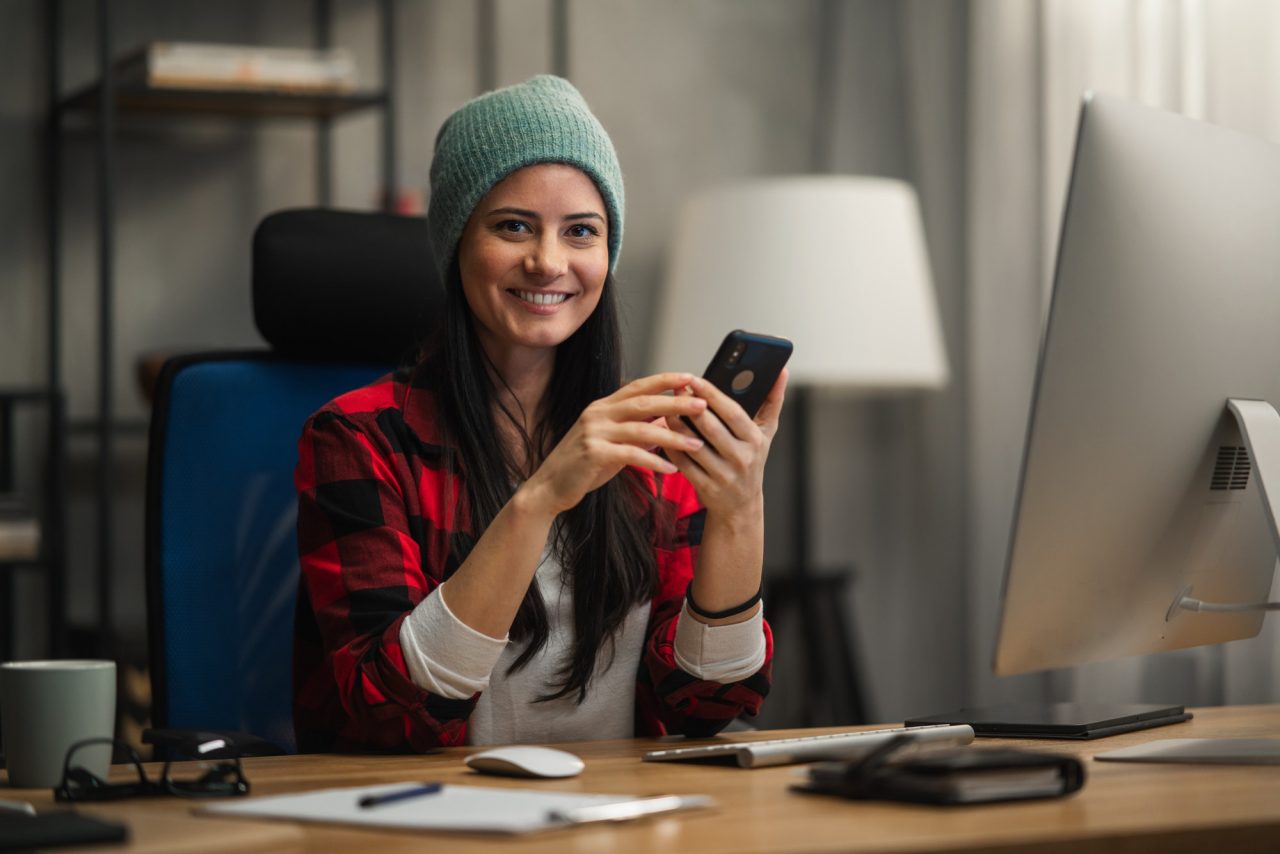 happy-female-video-editor-works-indoors-in-creative-office-studio-looking-at-camera.jpg